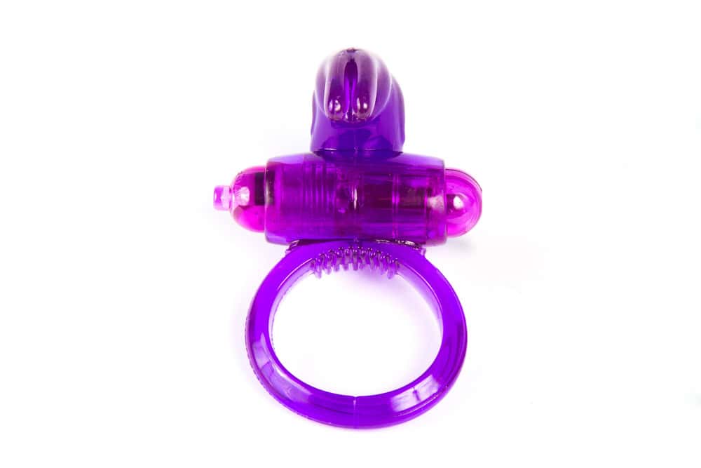 A purple silicone vibrating ring with a small bullet-shaped vibrating component attached on top-one of the best hotwife toys to spice up shared adventures.